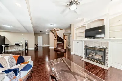 a living room with a fireplace and a tv at cozy two bedrooms with external bathroom just for you in Calgary