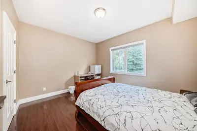 a bedroom with a bed and a window at cozy two bedrooms with external bathroom just for you in Calgary