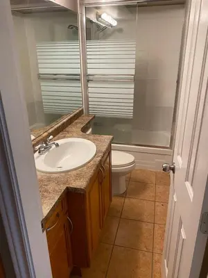 a bathroom with a sink and a toilet at Large suite with separate access in Richmond