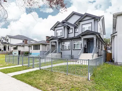 a house with a fence in front of it at Dumfries Guest Room in Vancouver in Vancouver