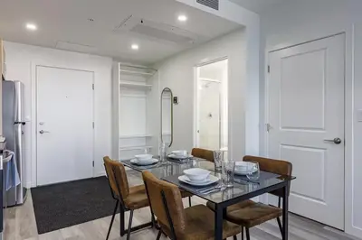 a dining room with a glass table and chairs at DT Edmonton King Suite with Parking & 100 Walk Score in Edmonton