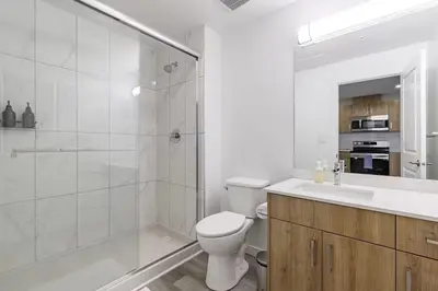 a bathroom with a toilet and a shower and a sink at DT Edmonton King Suite with Parking & 100 Walk Score in Edmonton