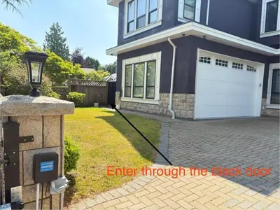 a house with a driveway with a white garage at Kane Jolly Lodge in Richmond