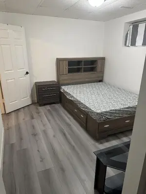 an empty room with two beds and a door at Valley Gateway in Calgary