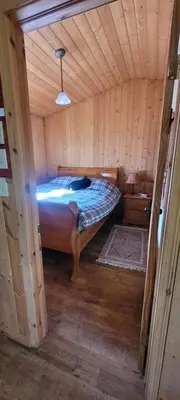 a bedroom with a bed in a wooden cabin at Beautiful Cabin near Radium Hot Springs with private hot tub in Radium Hot Springs
