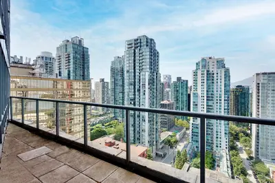 a balcony with a view of a city at Luxury 2BR Designer Apartment In The Heart Of Downtown! in Vancouver