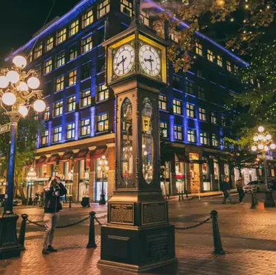 a clock tower on a street in front of a building at Luxury 2BR Designer Apartment In The Heart Of Downtown! in Vancouver