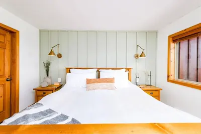 a bedroom with a white bed with two night stands at Perfection South 1 in Big White