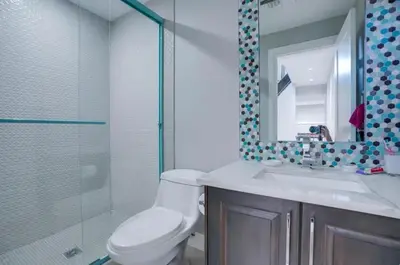 a bathroom with a toilet and a sink and a shower at Luxury Chestermere Retreat in Calgary