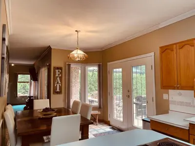 a kitchen and dining room with a table and chairs at The HI-Mark House - Hot tub,AC,Pool table, Pool May2026 in Sicamous