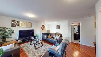 a living room with couches and a flat screen tv at Cozy comfy and relaxing home at Cougaridge SW Calgary in Calgary