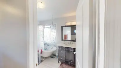 a bathroom with a tub and a sink and a toilet at Cozy comfy and relaxing home at Cougaridge SW Calgary in Calgary