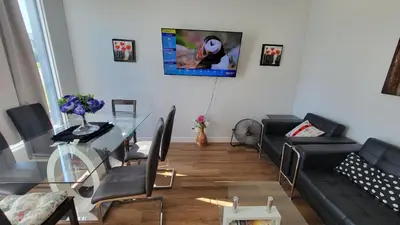 a living room with a glass table and a couch at 3 Bedroom House Near Airport and Downtown in Calgary