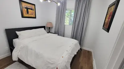 a bedroom with a white bed and a window at 3 Bedroom House Near Airport and Downtown in Calgary