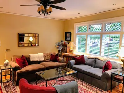 a living room with couches and a ceiling fan at Shaughnessy Heritage Manor on Vancouver's Westside free housekeeping optional in Vancouver