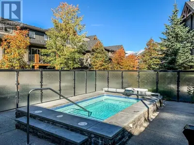 a hot tub in the backyard of a house at Best 2BR Canmore Stay, Banff, Wifi & Free Parking Incl in Dead Man's Flats