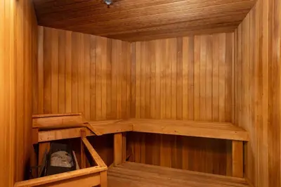a sauna with wooden paneled walls and wooden shelves at 1BR and Sofabed in Marquise, Near Ski Hill, Fireplace, Hot Tub and Sauna, Gym Access in Whistler