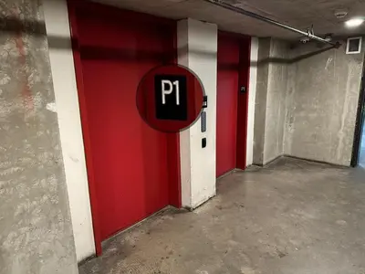 a red and white wall with a parking sign on it at Urbanest - Spectacular Views & Amenities Parking in Calgary