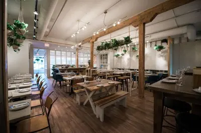 a restaurant with tables and chairs in a room at Urbanest - Spectacular Views & Amenities Parking in Calgary