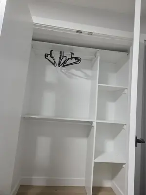 an empty white refrigerator with a shelf in a room at Exclusive Suite in Edmonton in Edmonton