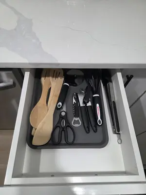 a drawer filled with knives and other kitchen utensils at Exclusive Suite in Edmonton in Edmonton