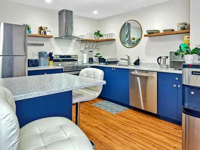 a kitchen with blue cabinets and stainless steel appliances at Renovated Suite in WL, 5 Min to Downtown, All New Appliances, Self Check-In in Williams Lake