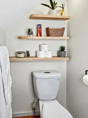 a bathroom with a toilet with wooden shelves at Renovated Suite in WL, 5 Min to Downtown, All New Appliances, Self Check-In in Williams Lake