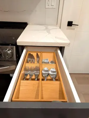 a kitchen with a wooden drawer with utensils at Luxury Guest Suite in Calgary in Calgary
