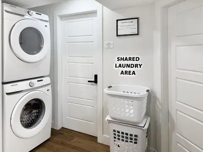 a laundry room with a washer and dryer at Private Studio - 5 Min to DT - Self Check-In - 75 Inch TV in Williams Lake