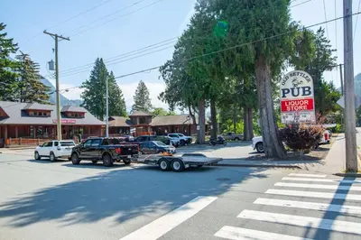 a car hooked up to a truck on a street at The Driftwalk Walkable to Beach in Harrison Hot Springs