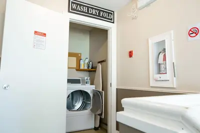 a laundry room with a washer and dryer at The Driftwalk Walkable to Beach in Harrison Hot Springs