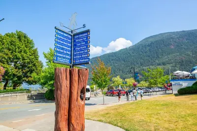 a sign on top of a wooden tree stump at RiversTail Retreat Pet-Friendly and Steps to The Lake in Harrison Hot Springs