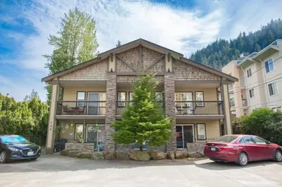 a house with two cars parked in front of it at The Backyard at Cedar Springs Walk to Lake and Hot Springs in Harrison Hot Springs