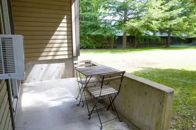 a table and two chairs sitting on a porch at The Backyard at Cedar Springs Walk to Lake and Hot Springs in Harrison Hot Springs