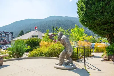 a statue of a monkey standing in a park at The Flats at Cedar Springs with Full Kitchen and Steps to Lake in Harrison Hot Springs