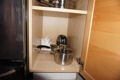 a small cabinet with a pot and a tea kettle at Hotel Room 2 in Coquitlam