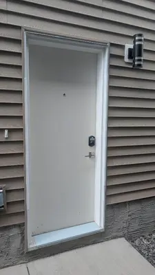 a white door on the side of a house at Cozy Escape Guest Suite in Edmonton