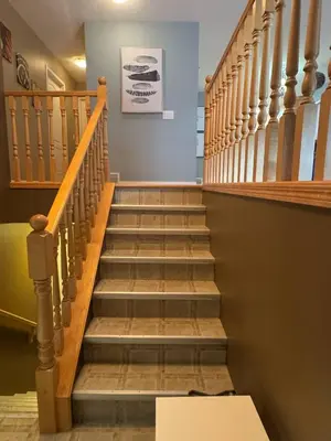 a staircase in a house with wooden railings at Heavenly Cozy Place Inc in Airdrie