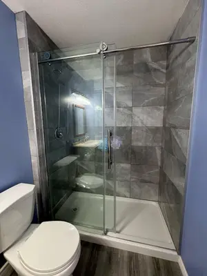 a bathroom with a shower and a toilet at Heavenly Cozy Place Inc in Airdrie