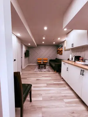 a living room with a couch and a table at Spacious 2 bedroom 3 beds lower unit with separate entrance and parking space Near Downtown, Calgary Zoo, Costco and many more in Calgary