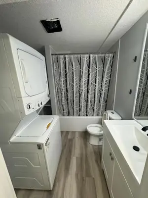 a small bathroom with a sink and a toilet at Spacious 2 bedroom 3 beds lower unit with separate entrance and parking space Near Downtown, Calgary Zoo, Costco and many more in Calgary