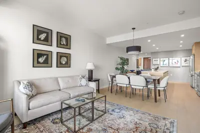 a living room with a couch and a table at Sidney Sunnyside - Luxurious Seaside Living in Amazing Sidney by Victoria Prime! in Sidney