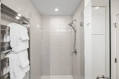 a bathroom with a shower with white towels at Sidney Sunnyside - Luxurious Seaside Living in Amazing Sidney by Victoria Prime! in Sidney