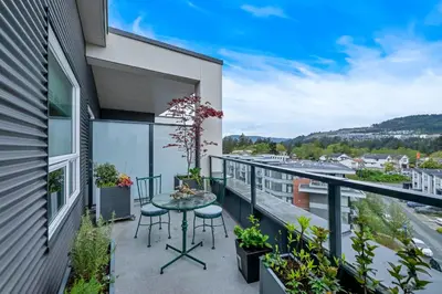 a balcony with a table and chairs at Whirlaway – Luxurious one bedroom Penthouse with study and 2 parking spots by Victoria Prime! in Victoria