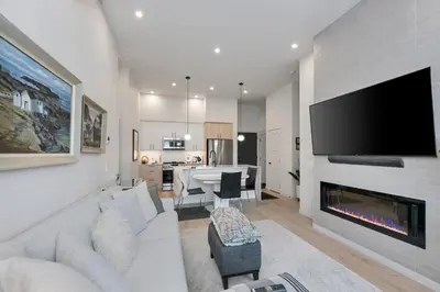 a living room with a couch and a fireplace at Whirlaway – Luxurious one bedroom Penthouse with study and 2 parking spots by Victoria Prime! in Victoria