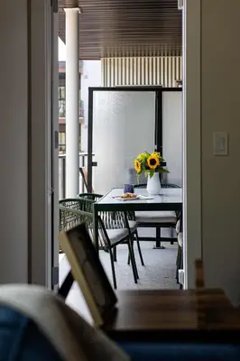 a room with a table with a vase of flowers on it at Riverstone Retreat in Golden BC in Golden