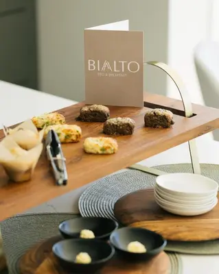 a table with plates and bowls of food on a table at Bialto Bed and Breakfast in Penticton