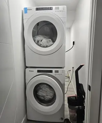 a washing machine and a washer in a room at Studio Suite in Northeast, Edmonton in Edmonton