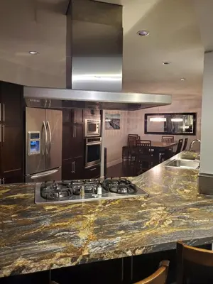 a kitchen with a granite counter top and a stove at Just across from the lake ! in Kelowna