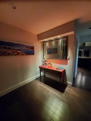 a room with a table and a painting on the wall at Just across from the lake ! in Kelowna